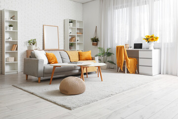 Interior of modern living room with workplace and sunflowers in vase