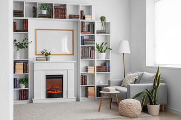 Interior of modern home library with bookshelves, sofa, coffee table and fireplace