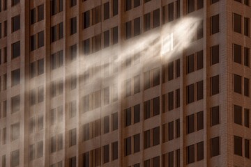 Light streams from a high-rise window, illuminating dust motes