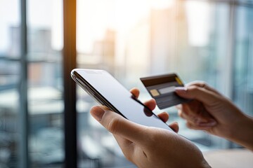 Close-up of hands holding a smartphone and credit card, likely for online shopping (1)