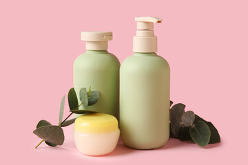 Set of natural cosmetic products and eucalyptus branches on pink background