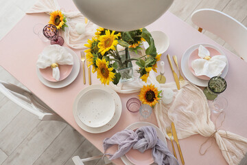 Elegant table serving with plates, glasses and beautiful sunflowers, top view