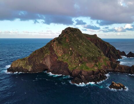 Dramatic coastal island, dramatic cliffs, rolling waves