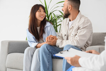 Obraz premium Happy young couple visiting fertility doctor about IVF in clinic