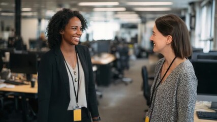 Collaboration in the Modern Workplace: Two business colleagues share an affable moment within a contemporary office setting, capturing the essence of collaboration and workplace culture.