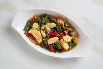 Homemade stir-fried long beans and baby corn. Perfect for recipes, articles or any cooking content.