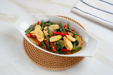 Homemade stir-fried long beans and baby corn. Perfect for recipes, articles or any cooking content.