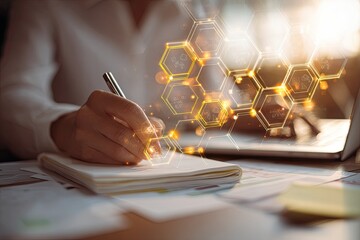 Person taking notes with a pen, overlayed with golden, abstract hexagonal shapes
