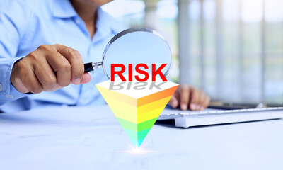 risk management concept with businessman using magnifying glass to searching for root cause of...