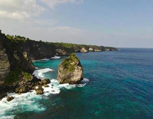 Fototapeta premium Dramatic coastal scene with turquoise waters crashing against dark volcanic rock formations