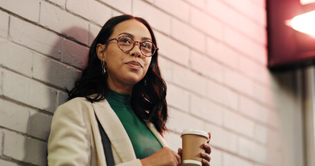 Businesswoman, coffee and memory in city at night, thinking and reflection with warm beverage on...