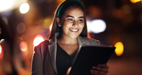 Woman, tablet and happy in town at night, scroll or booking taxi for commute on business trip....