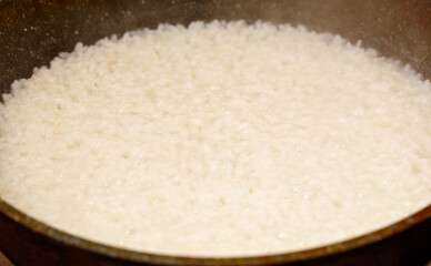 Pan of rice is cooking in a pan