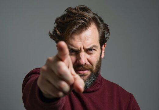 Angry man pointing finger accusing and threatening someone