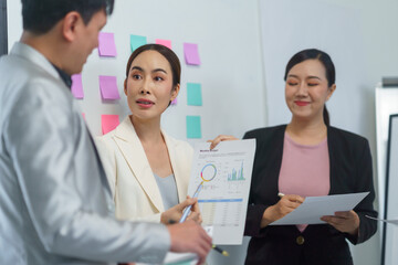 Business team engaging in a discussion about financial reports during a meeting in the office, collaborating on strategies and planning