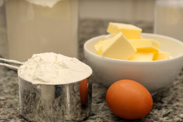 Eggs, Flour, and Butter Ingredients for Baking on Kitchen Countertop