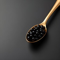 Golden Spoon with Black Caviar on Matte Black Surface
