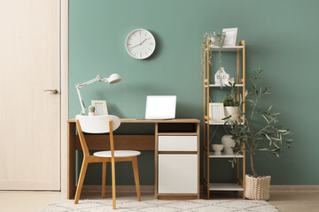 Interior of office with wall clock, workplace and shelf unit