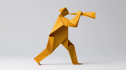 A vibrant yellow origami figure of a musician playing a trumpet, showcasing artistry and creativity in paper folding.