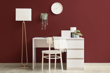 Interior of office with wall clock, workplace and lamps