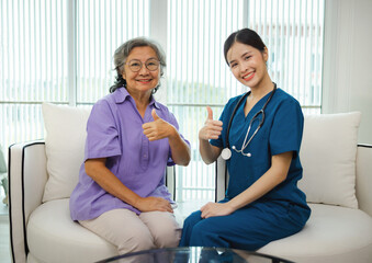 Obraz premium woman in purple shirt is giving thumbs up to woman in blue scrubs