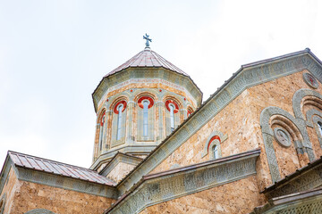 A detailed view of a Georgian Orthodox church with its beautifully decorated dome, arched windows,...