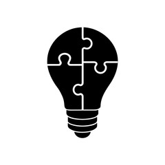 puzzle piece silhouette  fitting into a lightbulb 