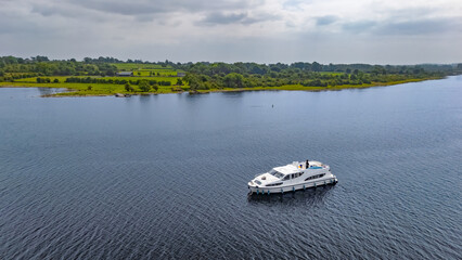 Aerial drone view of vacation motor boat in river Shannon from above, family travel by motorboat,...