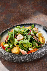 Grilled octopus salad with roasted potatoes and green beans, bright lighting, overhead composition
