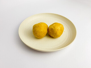 Tahu bulat is round tofu, snack made from soybeans, served on a round plate. Indonesian food.