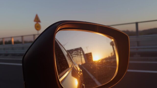 Golden Sunset Reflection in Car Side Rearview Mirror on Highway.  Travel and Transportation