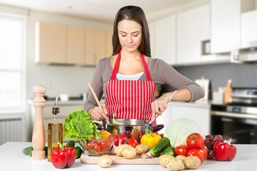 Shot of beautiful young woman cooking healthy food