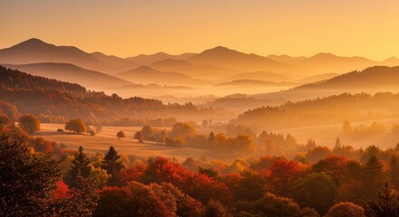 A golden autumn sunrise paints a tranquil mountain landscape, with vibrant fall foliage and hazy, misty valleys.
