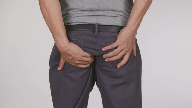 Hemorrhoidal pain, man with hemorrhoids on white background.