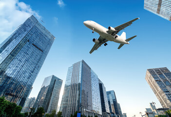 Naklejka premium An airplane gracefully glides through the air above a contemporary urban landscape filled with sleek glass skyscrapers