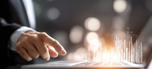Business hand interacting with holographic data visualization on a laptop