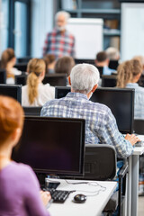 A training room where a younger tech specialist teaches older employees how to use new software