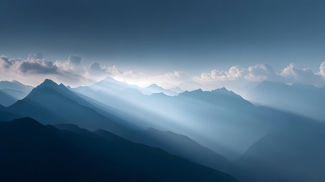Mountain peaks with sunlight breaking through cloud
