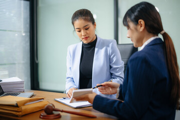 Obraz premium Professional female lawyers consulting on legal cases in a modern office. Perfect for law, business, justice