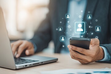 Businessperson using laptop and smartphone, digital user icons overlayed