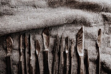 Rustic metal tools arranged on fabric