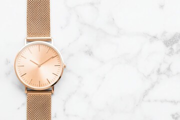 Rose gold watch on marble background