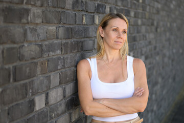 Pensive Woman Leans On Wall