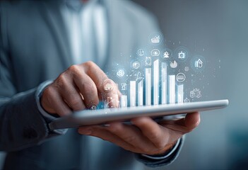 Close-up of hands holding tablet with 3D bar graph and business icons