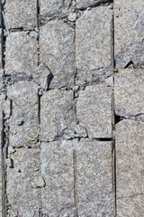 A close-up of stone and other materials, with random shapes arranged in succession to create an interesting design.