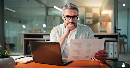 Thinking, laptop and documents with business man in office for budget research, planning and idea. Profit chart, account review and paperwork with person in agency for finance, balance and vision © peopleimages.com