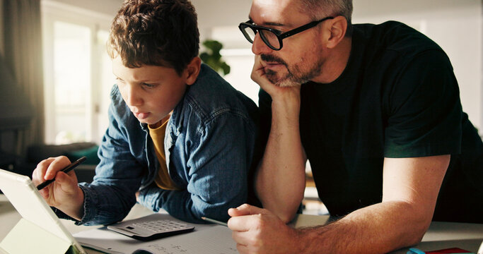 Tablet, homework and reading with father and son in kitchen for learning app, education or teaching. Growth, online school schedule and support with man and kid in family home for help and math tutor - Powered by Adobe
