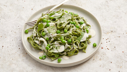 Homemade spinach pasta with creamy sauce