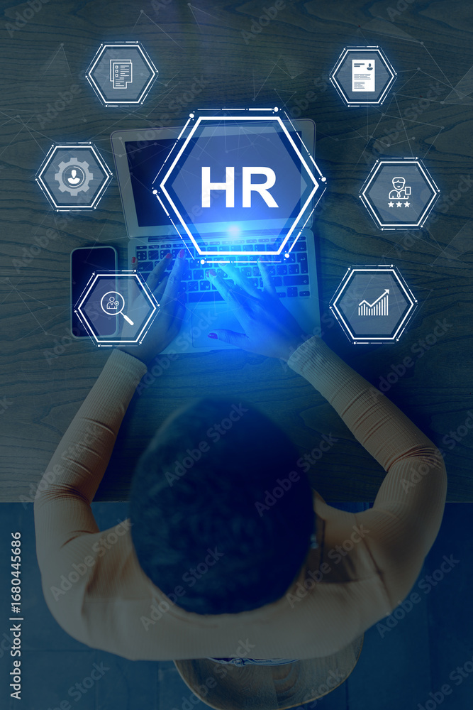 Poster human resources professional engaged in data analysis at a modern office workspace using a laptop an