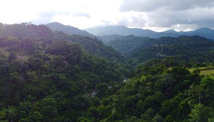 Lush green mountain valley, sunlight through clouds